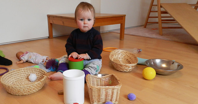 Kleinkind inmitten von Spielsachen